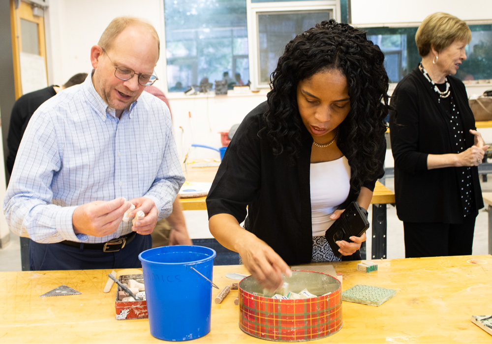 Members of the OVPI retreat work on an Arts@Work ceramics activity.