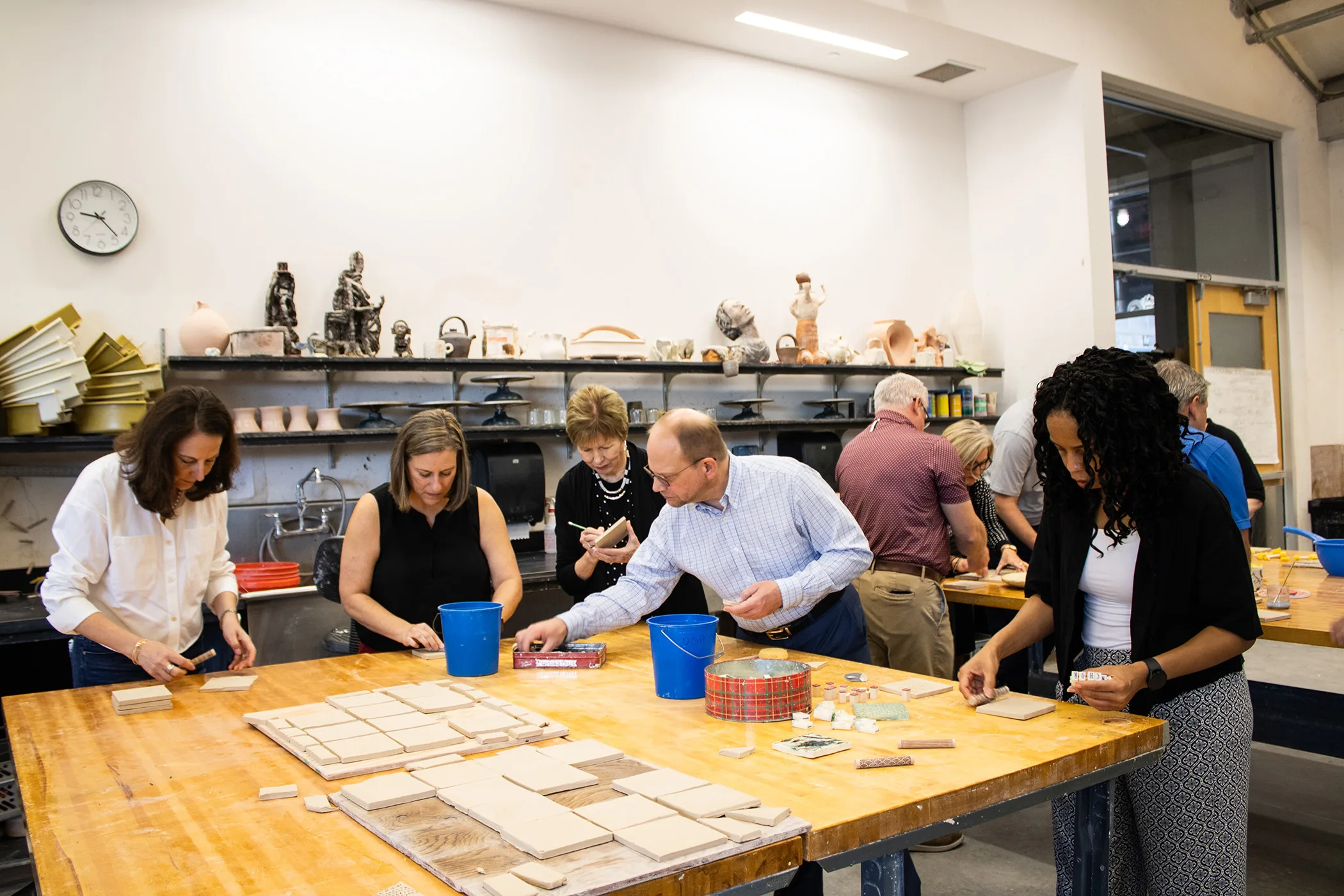 Participants decorate clay tiles during the Office of Instruction's annual leadership retreat. The art activity was held as part of UGA's new Arts@Work program. (Photo by Lily Ding)